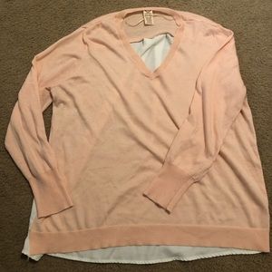 Baby pink sweater that has a white flowy back
